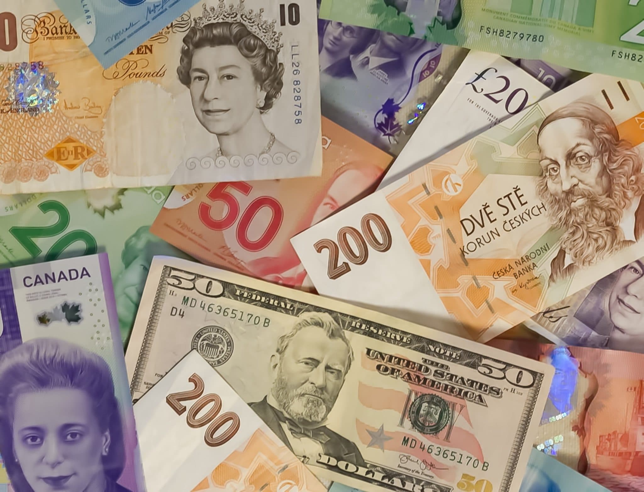 Banknotes from several countries fanned out in a pile